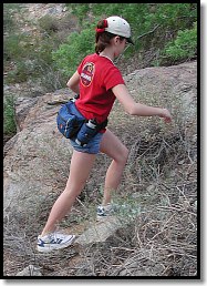 Bright shirt, cap, fanny pack with gear and water - she's equipped to survive!